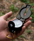 Holding Durable Wilderness Survival Compass for Orienteering And Outdoor Navigation with folding metal floating dial