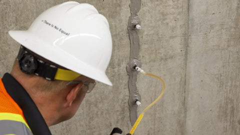 Worker using Flex-H20 Polyurethane Crack Sealer Injects Deep Into Concrete And Masonry Cracks From Tiny To Quarter Inch