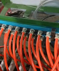 Two Pack 3 Way One Half Inch Air Manifold Block Splitter Inline Fittings in use with multiple orange hoses attached