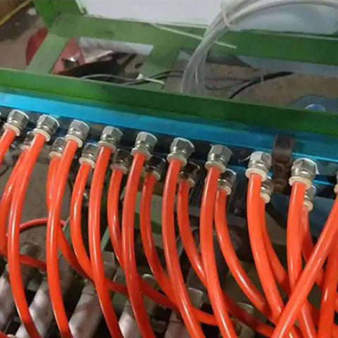 Two Pack 3 Way One Half Inch Air Manifold Block Splitter Inline Fittings in use with multiple orange hoses attached