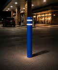 Heavy Duty Blue Safety Bollard Cover 6 Inch Diameter X 46 Inch with High Visibility Reflective Tape at night in a parking lot.
