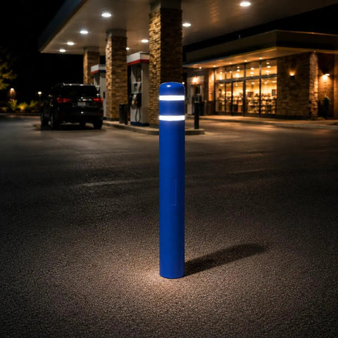 Heavy Duty Blue Safety Bollard Cover 6 Inch Diameter X 46 Inch with High Visibility Reflective Tape at night in a parking lot.