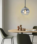 Dope Modern Black Globe Pendant Lights Two Pack, Glass Silver Gradient Orbs over dining table, soft warm glow