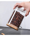 Hella Airtight Hand Blown Glass Coffee Canister With Spoon For Top Shelf Kitchen Organization showcasing coffee beans inside