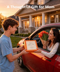 Woman receiving a Mother's Day gift and flowers from a young man by a car.