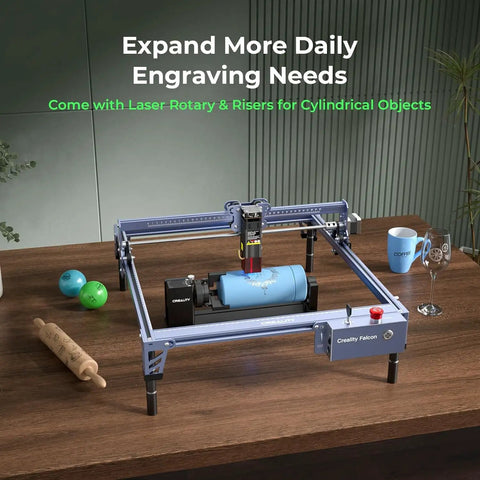 Falcon 10W Laser Engraver With Air Assist And Rotary Roller, engraving cylindrical tumbler, on a wooden table setup.