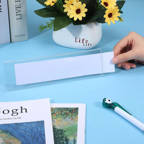 Pack Of 18 Clear Acrylic Desk Name Plates 2 By 8 Inches Blank Customizable Horizontal Slant being inserted on desk