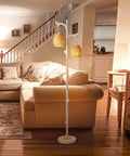 68 Inch Farmhouse Floor Lamp With Tree Trunk Faux Wood Column And White Washed Wicker Drum Shade in cozy living room setting.