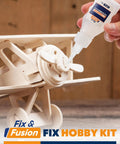 Applying cyanoacrylate glue from the Cyanoacrylate Glue And Instant Activator Spray Set on a wooden hobby airplane model.