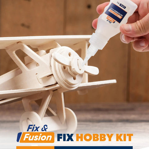 Applying cyanoacrylate glue from the Cyanoacrylate Glue And Instant Activator Spray Set on a wooden hobby airplane model.