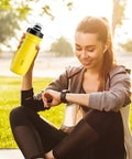 Person holding a yellow 18 Oz Spill Proof Water Bottle For Camping And Outdoors, Easy Squeeze Hydration Bottle Built For Hiking