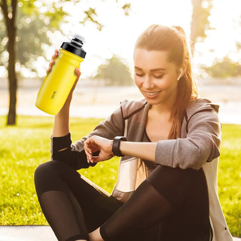 Person holding a yellow 18 Oz Spill Proof Water Bottle For Camping And Outdoors, Easy Squeeze Hydration Bottle Built For Hiking