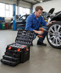 Mechanic using Durable 297-Piece Mechanic Tool Set With Quarter Inch, Three Eighths Inch, And Half Inch Drive Sockets in auto repair.