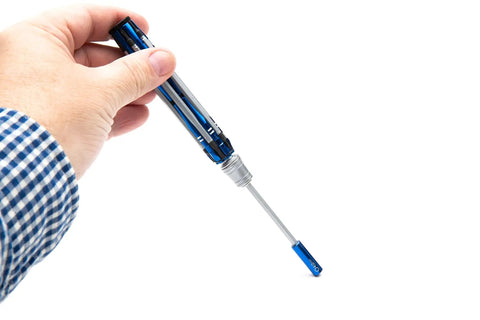 Hand holding Pro Grade Do It All RC Tool Set aluminum handle with hex tip for surface and air repairs.