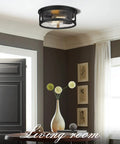 Super Cool Black Flush Mount Ceiling Light With Metal Cage Design And Seeded Glass Shade For That Awesome Industrial Farmhouse Vibe In Your Kitchen Hallway Or Bedroom Twelve Inch Size Needs Two E26 Bulbs in living room