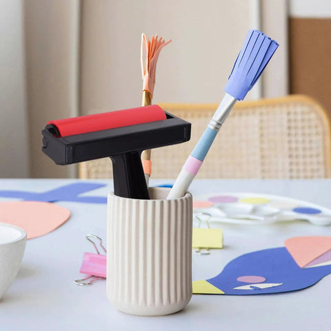 Solid Grip Rubber Paint Roller For Printmaking And Classroom Art Projects in a holder with pencils and craft materials.
