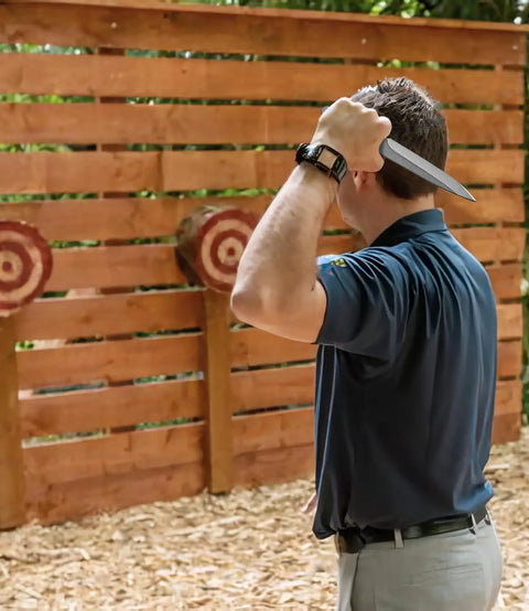 Person preparing to throw 10.2 Inch Throwing Spear Set, 0.236 Inch Thick Full Tang, at a target for precision training