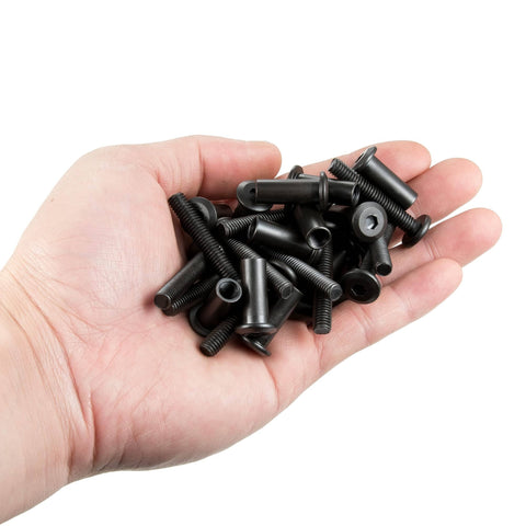 Close-up of a hand holding 40 Sets Black M6 Bolts And Nuts Cap Nuts Assortment Kit with metallic black finish for hardware replacement.
