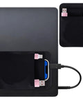Stick On Dual Pocket SSD Carrying Case With Reusable Adhesive For Laptops And External Drives attached to a laptop.