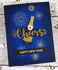 Wine Glass Clear Stamp And Die Set For Card Making with embossed 'Cheers' design and 'Happy New Year' banner on blue card
