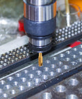 Close-up of Spiral Point Tap 5 By 16 By 18 UNC B2 Accuracy Titanium Coated Pro Grade 6542 High Speed Steel in metalworking machine