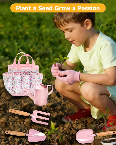 Eight Piece Kids Gardening Tool Set With Shovel Rake Watering Can Hat Apron Gloves And Storage Bag Pink Flower Theme in use by toddler