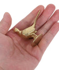 Top Shelf Brass Pheasant Drawer Knob With Rich Golden Finish held in hand, showcasing intricate design and tarnish-proof material.