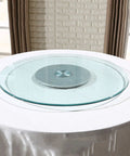 Adjustable Rotating Lazy Susan Turntable With Tempered Glass Top And Heavy Duty Aluminum Base Featuring Slick Rolling Bearings on a table.
