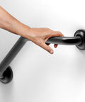 Hand holding 16 Inch Angled Shower Grab Bar ADA Compliant With 500 Lb Load Capacity Glacier Collection in Brushed Nickel Finish