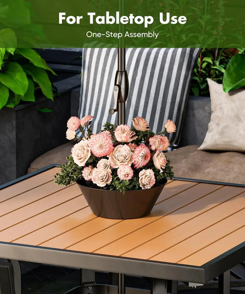 No Fuss 2 In 1 Umbrella Planter For Patio Table And Pole With Umbrella Hole Fits Poles Up To Two Inches Diameter Half Round Flower Pots Wrap Around PVC Post Black shown on table with flowers.
