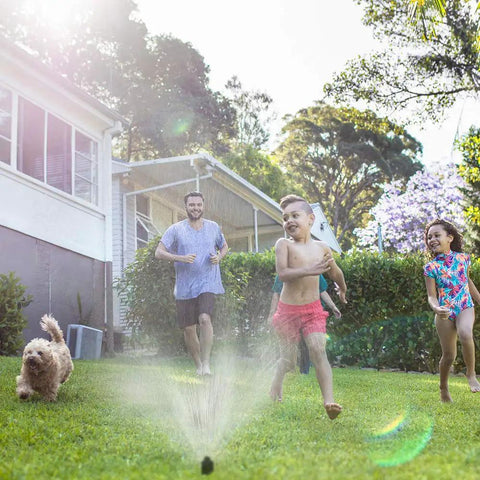 Family enjoying garden with WiFi Smart Sprinkler Controller Ditch The Dial With 8 Zone Irrigation, App Based Scheduling.