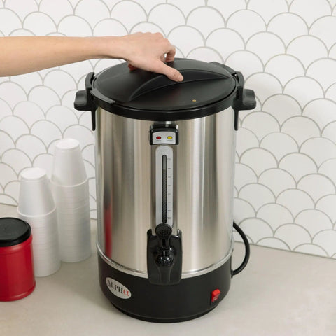 Person using 100 Cup Electric Coffee Urn Stainless Steel Beast With Massive Capacity Percolator Pot And Leak Proof Tap Hot Beverage Dispenser.