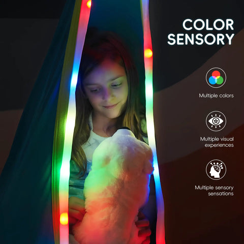 Child sitting inside Light Up Pod Swing Seat For Kids With LED Lights, Sensory Hammock Chair in Cotton, enjoying calming sway, blue.