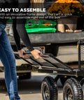 Person assembling Heavy-Duty Steel Utility Cart With 4 Cu Ft Bed And 900 LB Load Capacity, Black Towable Hauling Wagon.