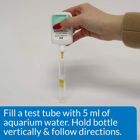 Slick Freshwater Aquarium GH And KH Water Test Kit featuring pro level liquid reagents dispensing into a test tube for measurement.
