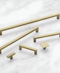 Solid Core Kitchen Cabinet Pulls With Luxe Golden Nickel Finish For Doors And Dressers, 12 Inch Center, hardware set on marble surface