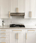 White kitchen with Champagne Bronze Cabinet Pulls 5 Inch 128mm Solid Zinc Alloy Handles installed on drawers and cabinets.