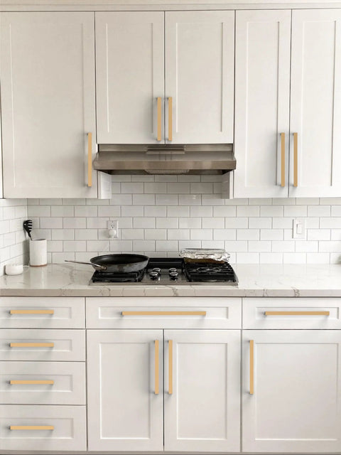 White kitchen with Champagne Bronze Cabinet Pulls 5 Inch 128mm Solid Zinc Alloy Handles installed on drawers and cabinets.