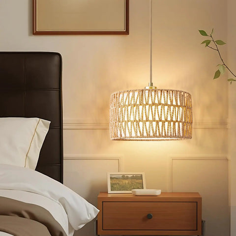 Level Up Your Chill Zone With This Hand Woven Rattan Plug In Pendant Light Farmhouse Hanging Lamp featuring warm glow over bedside table.