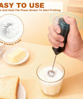 Handheld Milk Frother Battery Operated Electric Foam Maker Wand With Stainless Steel Whisk frothing milk in glass