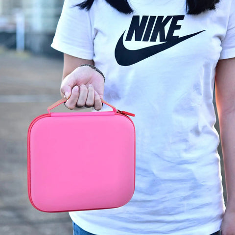 Person holding Pink Universal Case For LED Neck Reading Light, Portable Storage Holder For USB Cable And Book Light