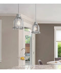 Retro Vibe One Light Indoor Mini Pendant Light With Hand Blown Clear Glass Shade And Brushed Nickel Finish over kitchen island