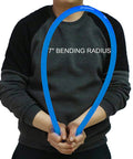 Person holding 1 Inch PEX B Non Oxygen Barrier Flexible Pipe Tubing Blue For Hydronic Radiant Floor Heating EVOH Water Plumbing Applications Includes Cutter And Clamps In Box For Easy Install 300 Ft Roll, demonstrating 7-inch bending radius.