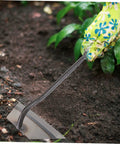 Gardener using 4-Piece Garden Hoe Set For Weeding And Soil Loosening with wear-resistant blade in flower bed