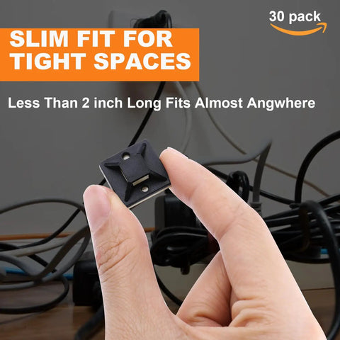 Hand holding 140 Pack 3/4 Inch Zip Tie Adhesive Mounts with cable messy in background, small black clip in focus.
