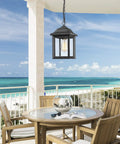 Rugged Outdoor Porch Chandelier With Seeded Glass Hanging Lantern In Sand Black Aluminum Finish on beachside porch