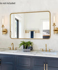 Modern Brushed Gold Wall Sconces Set Of Two With Clear Glass Hardwired Adjustable Up Or Down Vanity Light Fixture For Bathroom Smooth Vibe Upgrade in stylish bathroom setting.