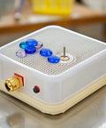 Glass grinder with colorful pieces, showcasing the Set Of 4 Diamond Glass Grinder Bits for stained glass tool kit in use.