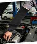 Premium Heat Resistant Welding Arm Sleeves Flame Retardant Cotton Guards With A Snug Elastic Fit Built Tough For Rough Job Sites And Heavy Duty Mechanic Work One Black Pair on a mechanic's arm.