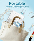 Portable Premium Ultrasonic Cleaner Juice For Bling Glasses And Sensitive Finds Wakes Up Muted Gems in a cloth bag.